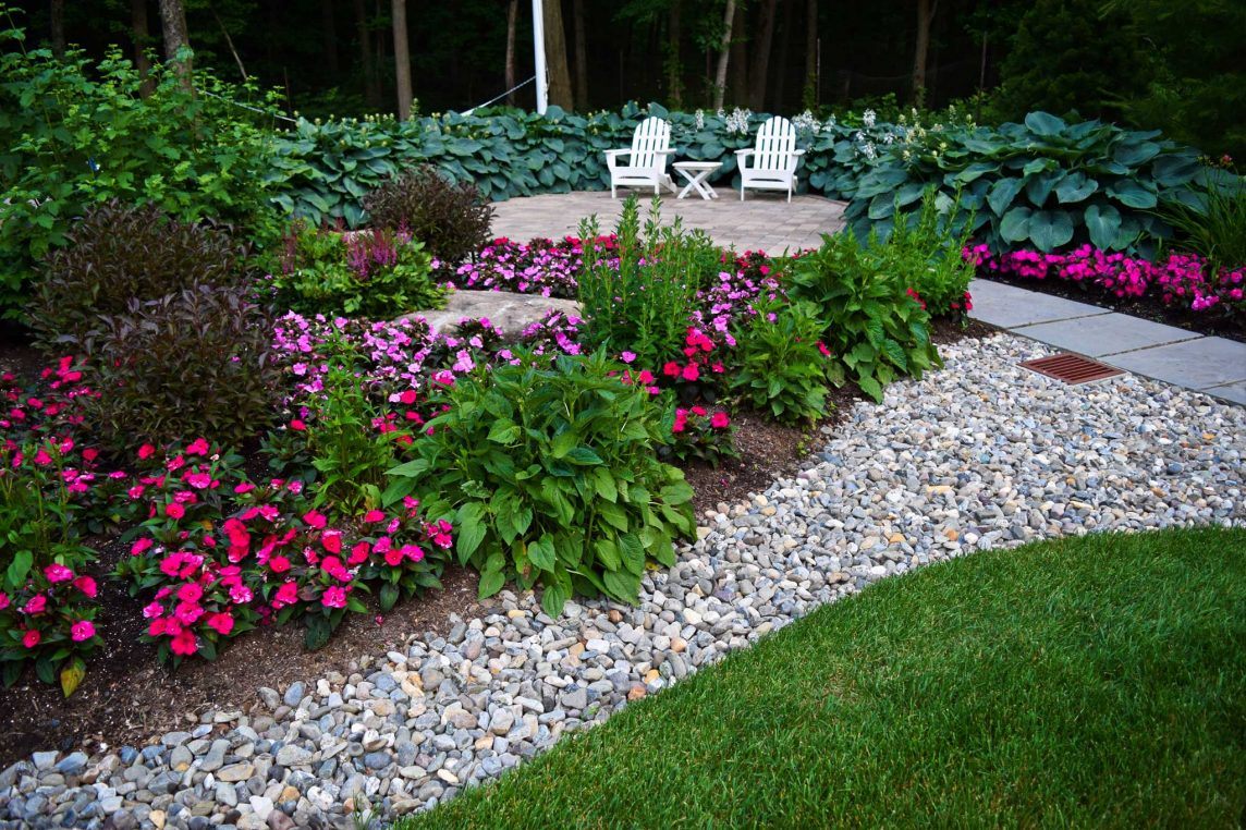 Neave Group’s stormwater management services create flourishing flower beds in shades of pink, purple, and white, along with lush green foliage.