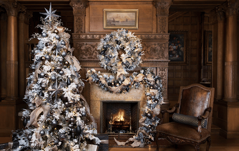 holiday and event decorations - Christmas tree near the fireplace