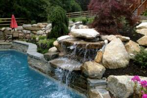 Modern swimming pool waterfall features at Connecticut residence