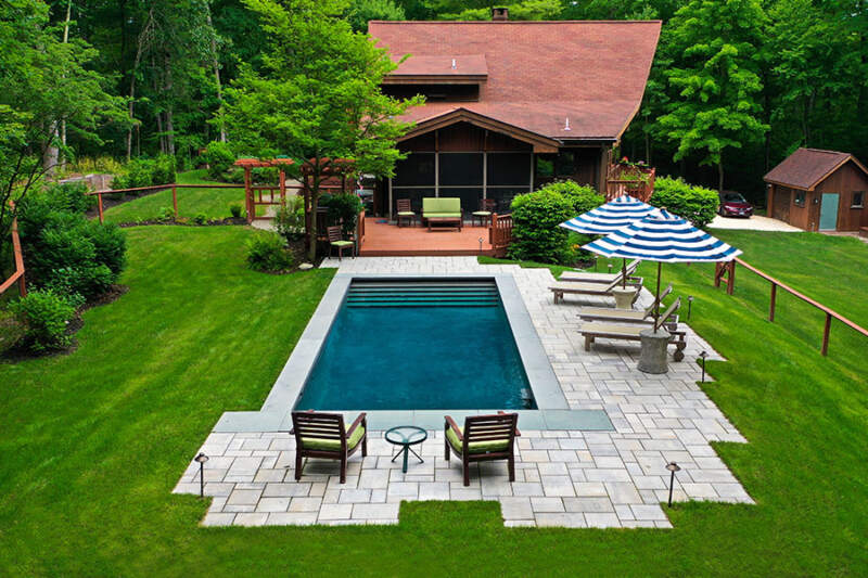 Elegant house with minimalist outdoor pool exemplifying premium new pool installation services in NY and CT