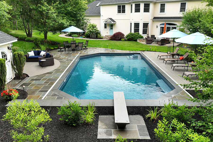 Majestic vinyl pool with a diving board showcasing professional pool installation
