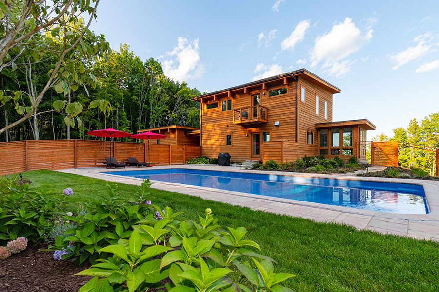 Secure privacy fence encompassing the house and outdoor pool area for enhanced safety and seclusion