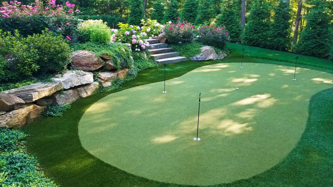 Backyard courts installed by Neave include this stunning construction of a putting green to practice your golf game