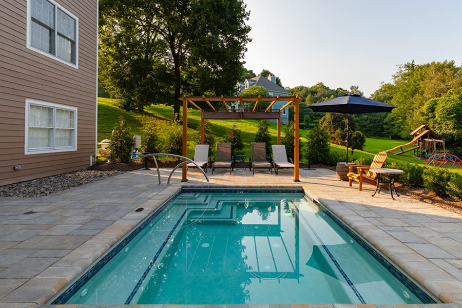 Plunge rectangular inground cocktail pools in a landscaped backyard, illustrating small pools designs for compact outdoor living